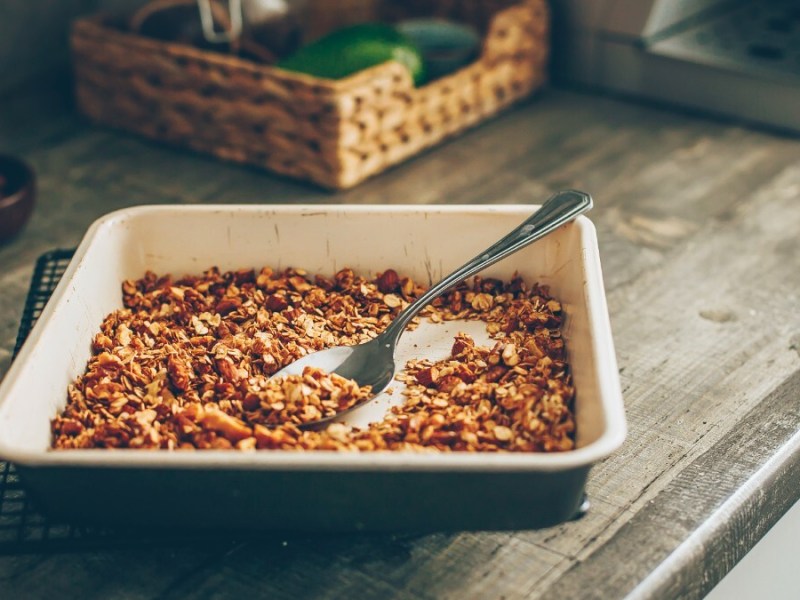 Roasted oats in a baking dish. It sits on a counter in the kitchen.