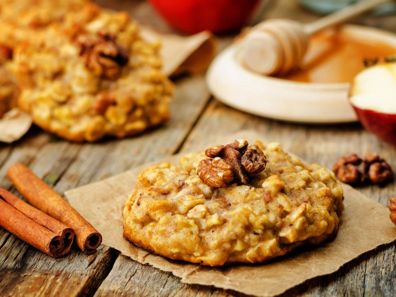 An oatmeal apple cookie on an autumnal table.
