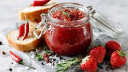 Jar of strawberry chutney on a table